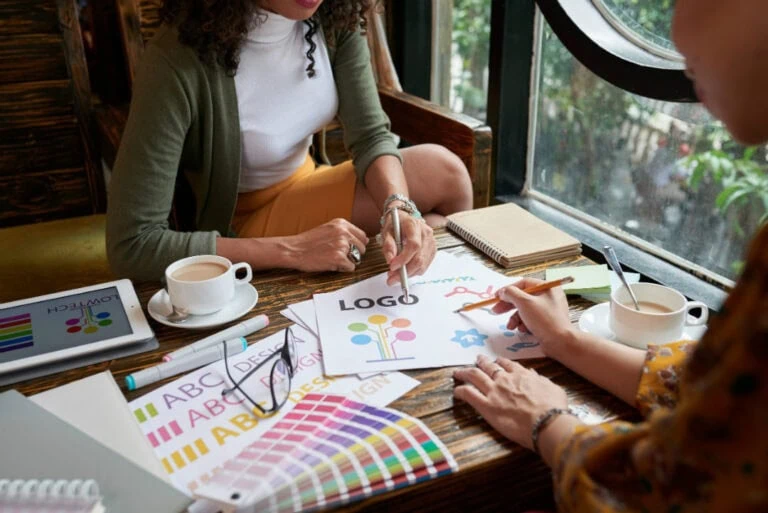 Two designers working together to create a logo